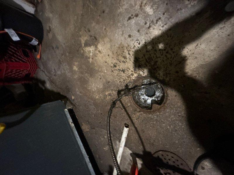 Responded to laundry room drain clog caused by tree root intrusion. Upon arrival, accessed the floor drain in the basement utility area and deployed mechanical cable snake to clear the blockage. Successfully removed root obstruction from the drain line, restoring proper drainage function to the laundry room plumbing system.