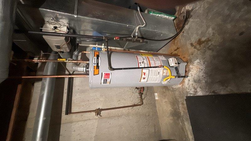 Installed a 50-gallon gas-fired water heater in residential basement mechanical room, including all necessary plumbing connections with copper piping. Added thermal expansion tank to system and installed ball valve shut-off on cold water inlet line for improved serviceability. Completed installation of humidifier shut-off valve as part of the overall system upgrade. All connections were properly secured, gas line attached, and unit tested for proper operation.