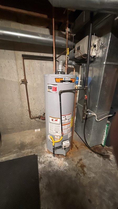 Installed a 50-gallon gas-fired water heater in residential basement mechanical room, including all necessary plumbing connections with copper piping. Added thermal expansion tank to system and installed ball valve shut-off on cold water inlet line for improved serviceability. Completed installation of humidifier shut-off valve as part of the overall system upgrade. All connections were properly secured, gas line attached, and unit tested for proper operation.