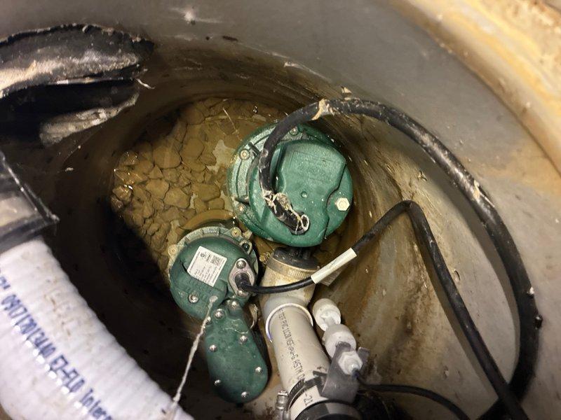 Responded to locked rotor error on existing basement sump pump system. Upon inspection, found multiple float switches and pump components in sump basin with standing water containing sediment and debris. Diagnosed locked rotor condition caused by debris accumulation interfering with pump operation. Cleared obstruction from pump intake, tested float switch operation and pump functionality to ensure proper cycling. Verified discharge system and electrical connections. System restored to normal operation with all components functioning correctly. Recommended periodic maintenance to prevent future debris-related issues.