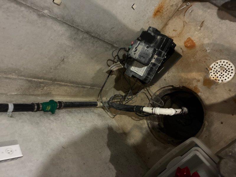Responded to service call for sump pump running continuously in unfinished basement area, requiring customer to unplug unit to stop operation. Upon inspection, diagnosed malfunctioning float switch causing pump to run without cycling off properly. Replaced defective float switch assembly and tested pump operation through multiple cycles to verify proper activation and deactivation at correct water levels. Inspected discharge piping system including PVC connections and check valve for proper function and secure mounting. Confirmed all electrical connections were secure and properly grounded. System tested successfully with pump cycling on and off as designed, restoring normal automatic operation.
