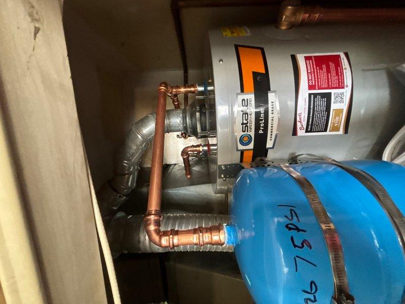 Completed installation of 40-gallon gas-fired water heater with thermal expansion tank in commercial mechanical room. All copper supply and discharge piping was properly connected, pressure relief valve installed per code requirements, and gas line connections verified for safe operation. System was tested and confirmed operational with no leaks detected.