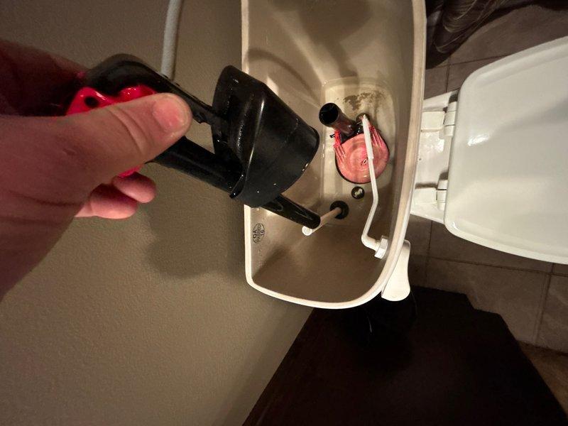 Responded to service call for continuously running toilets on main and lower levels. Performed diagnostic inspection of both toilet flush mechanisms using inspection camera to identify faulty components. Found deteriorated flush valve assemblies with pink plastic components causing constant water flow. Replaced defective flush valves and internal tank mechanisms on both toilets to restore proper operation and eliminate continuous running condition.