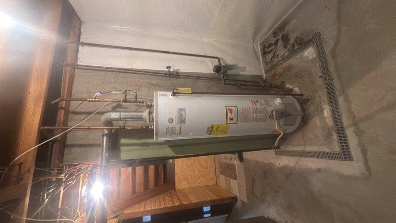 Responded to service call for multiple plumbing and fixture issues in residential bathroom. Corrected improperly installed shower valve that had been placed in backwards orientation, restoring proper hot/cold water function. Repaired and secured water heater flue connection to ensure proper venting and safety compliance. Secured loose bathroom vanity to wall, eliminating movement and potential water damage. Inspected and addressed drainage concerns in shower/tub area to ensure proper water flow and prevent future backup issues.