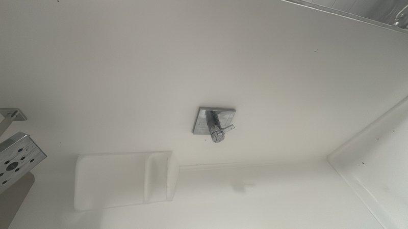 Responded to service call for multiple plumbing and fixture issues in residential bathroom. Corrected improperly installed shower valve that had been placed in backwards orientation, restoring proper hot/cold water function. Repaired and secured water heater flue connection to ensure proper venting and safety compliance. Secured loose bathroom vanity to wall, eliminating movement and potential water damage. Inspected and addressed drainage concerns in shower/tub area to ensure proper water flow and prevent future backup issues.