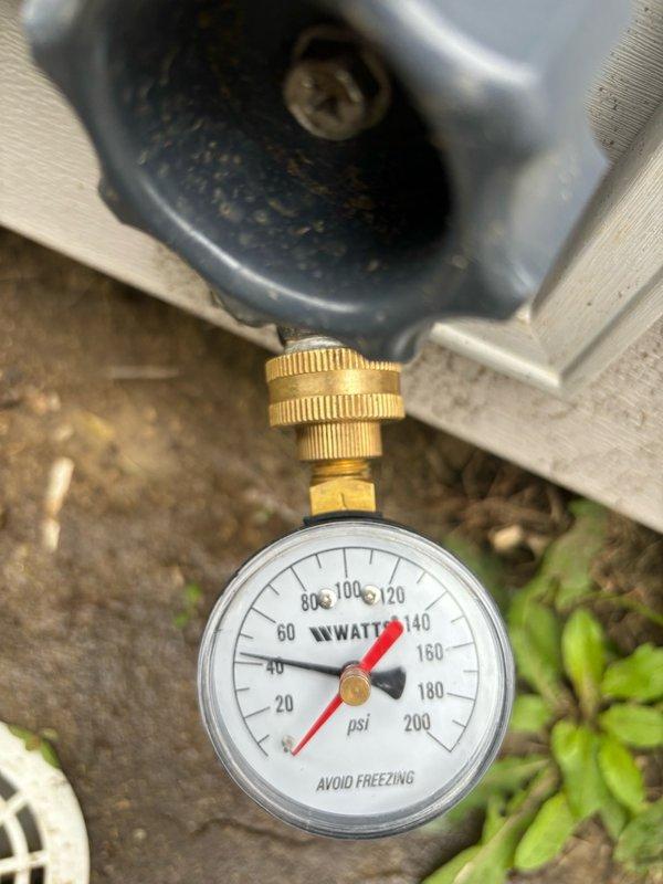 Completed comprehensive plumbing inspection of residential property. Evaluated interior shower system, confirming proper water flow and functionality of chrome handheld shower fixture with wall-mounted components. Inspected exterior water service connection and verified water pressure readings using calibrated gauge, which displayed normal operating pressure within acceptable range. All plumbing systems inspected were found to be in functional working condition with no immediate repairs required.