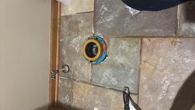 Removed and reset toilet to address reported seal issue. Pulled toilet from floor flange, removed old wax ring, and inspected flange for damage. Installed new wax ring seal and properly repositioned toilet, ensuring secure mounting and proper alignment with drain opening. Verified leak-free operation upon completion.