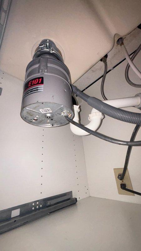 Responded to kitchen sink drain stoppage in 37-year-old residence with basement access. Upon arrival, confirmed clog location previously identified by homeowner and assessed that proper drain clearing equipment would be required. Accessed drain system from basement, utilizing professional drain auger to clear obstruction from kitchen sink line. Successfully removed blockage and restored full drainage flow. Tested system operation with water flow to verify complete clearance and proper drainage function. Inspected under-sink plumbing connections, garbage disposal unit (model E101), P-trap assembly, and supply line shut-off valves to ensure no secondary issues or leaks present. All components functioning properly upon completion.