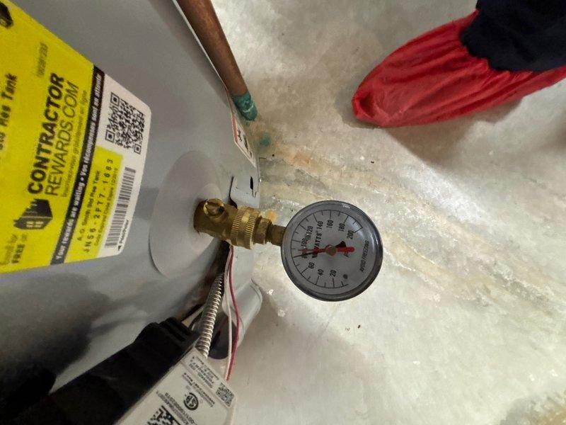 Replaced existing water heater with new 40-gallon gas water heater in basement with walk-out access. Installation included connecting copper supply lines, installing expansion tank with pressure gauge, configuring gas line with flexible connector, and establishing proper venting through existing ductwork. All plumbing connections were secured with appropriate valves and fittings, pressure relief valve installed per code requirements, and system tested for proper operation and leak-free performance.