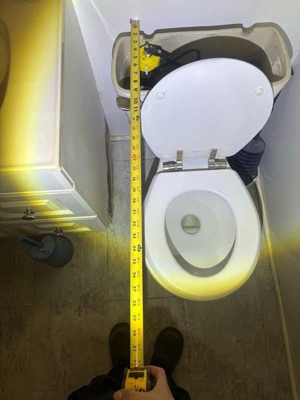 Responded to service call for reported bathroom toilet issue. Upon arrival, performed comprehensive inspection and measurement of existing toilet fixture to assess condition and determine appropriate repair or replacement specifications. Documented toilet dimensions including rough-in measurements and clearances for potential fixture replacement. Evaluated overall condition of toilet assembly, including bowl, tank, seat hardware, and water supply connections. Inspected surrounding flooring and identified wear patterns and discoloration around toilet base, noting potential need for wax ring replacement or floor sealing upon future service. Measured and photographed toilet installation specifications for accurate parts ordering and future reference.