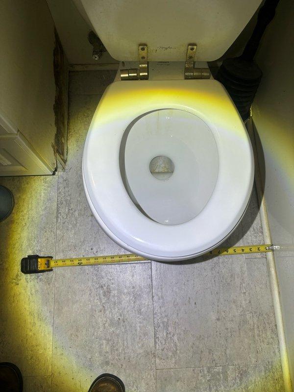 Responded to service call for reported bathroom toilet issue. Upon arrival, performed comprehensive inspection and measurement of existing toilet fixture to assess condition and determine appropriate repair or replacement specifications. Documented toilet dimensions including rough-in measurements and clearances for potential fixture replacement. Evaluated overall condition of toilet assembly, including bowl, tank, seat hardware, and water supply connections. Inspected surrounding flooring and identified wear patterns and discoloration around toilet base, noting potential need for wax ring replacement or floor sealing upon future service. Measured and photographed toilet installation specifications for accurate parts ordering and future reference.