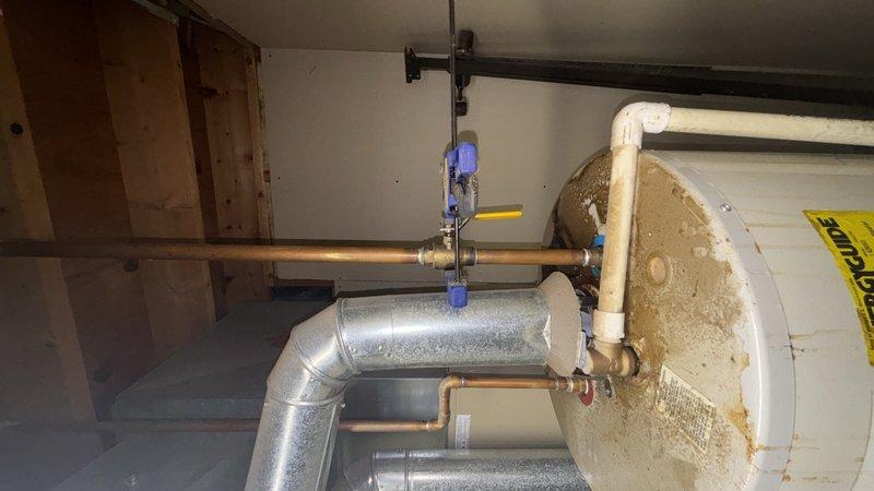 Responded to no hot water complaint in basement utility area. Upon inspection, diagnosed faulty heating element in tanked water heater. Replaced defective element, tested system operation, and verified hot water restoration. Unit returned to normal function with proper temperature output.