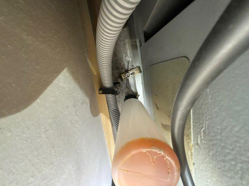 Responded to service call for leak under kitchen sink. Upon arrival, conducted thorough inspection of cabinet interior and plumbing connections. Located source of moisture at supply line connection point beneath sink basin. Identified loose compression fitting on cold water supply line allowing water seepage. 

Tightened compression nut to manufacturer specifications using appropriate wrenches. Inspected additional plumbing connections including P-trap assembly and hot water supply line for potential issues. Verified all connections were secure and properly sealed. Cycled water supply on and off multiple times while monitoring for any signs of leakage. Confirmed repair was successful with no visible moisture or dripping present. Documented conditions with photographs for service records. Left work area clean and dry with all plumbing fixtures functioning properly.
