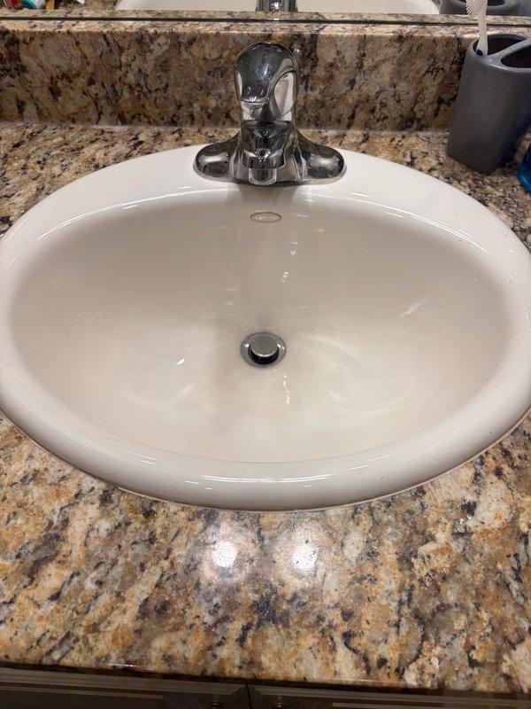 Replaced three single-handle chrome faucet sets in main floor bathrooms of a 24-year-old residence. Removed existing worn fixtures and installed new faucets with proper supply line connections and drain assemblies. Verified all connections for leaks, tested water flow and temperature control, and ensured proper drainage through P-trap configurations. All installations completed to code with fixtures functioning properly.