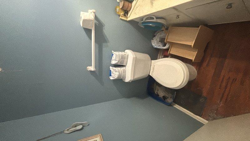 Responded to reported clogged toilet on upper level. Upon arrival, assessed the toilet and surrounding bathroom area, which showed signs of ongoing household activity with storage items present. Successfully cleared the toilet obstruction and restored proper drainage and flushing function. Verified system operation before completing service call.