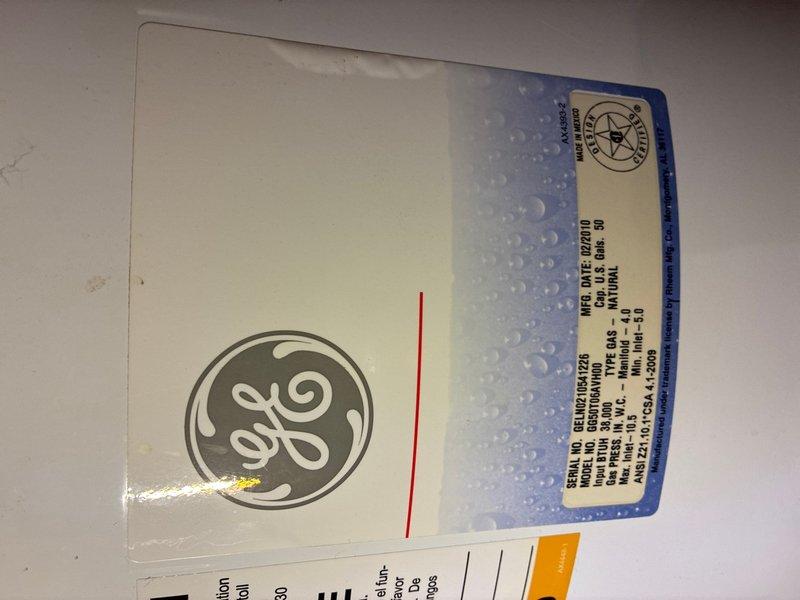 Responded to reported leak from 50-gallon water heater in basement. Upon inspection, identified leak originating from deteriorated pressure relief valve assembly, evidenced by significant corrosion and oxidation on copper piping and brass fittings. The General Electric water heater, manufactured February 2018, showed age-related wear on plumbing connections. Replaced faulty pressure relief valve, installed new brass fittings, and tested system for proper operation and seal integrity to resolve active water leak.