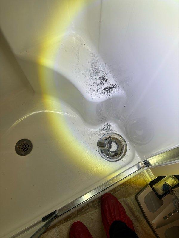 Responded to service call for leaking shower cartridge in bathroom. Upon arrival, inspected bathtub and shower assembly to identify source of leak. Removed existing drain components and cartridge assembly as documented in service photos. Customer had replacement cartridge on-site. Installed new shower cartridge, tested for proper operation and verified leak was resolved. Cleaned work area and ensured all plumbing fixtures were functioning correctly before completing service.