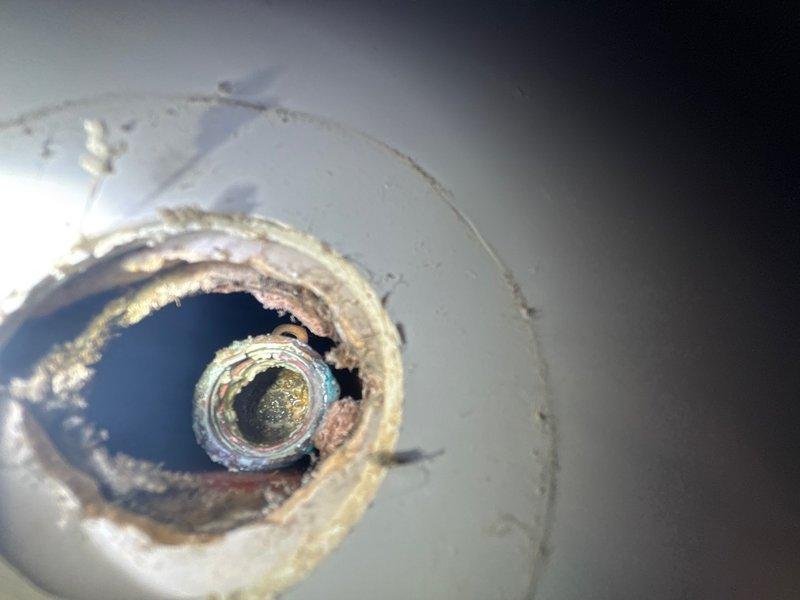 Responded to water leak from shower hot and cold supply lines in basement. Upon inspection, identified significant corrosion and deterioration at pipe penetration points through ceiling surface. Repaired leaking shower supply lines, addressed corroded pipe connections, and secured proper sealing at fixture stub-out to prevent further water intrusion.