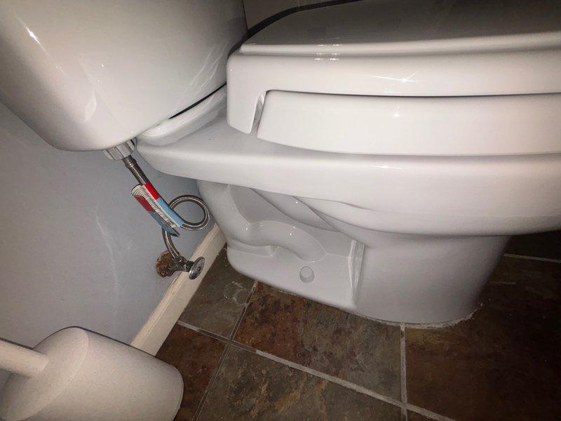 Completed installation of customer-supplied toilet in bathroom. Removed existing fixture and installed new two-piece toilet with wax ring seal to ensure proper connection to the waste flange. Connected chrome water supply line from wall shut-off valve to toilet tank fill valve, verified all connections for proper seal and function, and tested for leaks. Toilet is operational and ready for use.