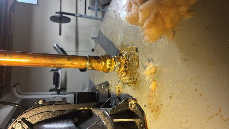 Responded to service call for a 7-year-old water heater with active leak from top connections. Upon inspection, identified significant water seepage from copper pipe connection at the tank inlet, evidenced by mineral deposits and water staining on surrounding surfaces and mounting hardware. Documented leak location and severity with photos. Researched manufacturer warranty information for the unit to determine coverage eligibility and provided customer with comprehensive repair versus replacement options based on age of equipment, extent of damage, and warranty status.