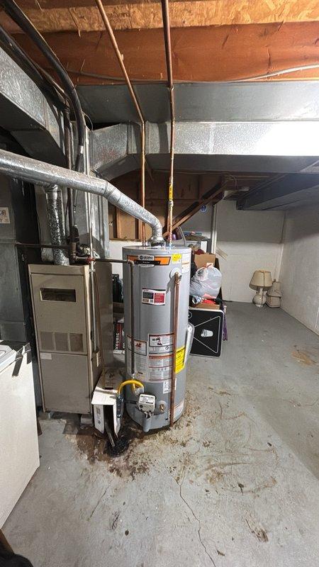 Installed a new 50-gallon gas water heater in the basement utility area, connecting copper supply lines with shut-off valves and proper insulation. The unit was positioned on a stable platform with gas line connection featuring a yellow shut-off valve for safety compliance. All plumbing connections were secured and tested to ensure proper operation of the residential water heating system.