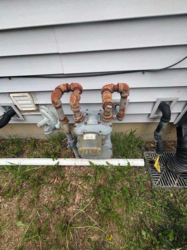 Conducted on-site evaluation for gas line installation from existing residential natural gas meter to heated pool location. Assessed current gas meter assembly with corroded copper piping connections, measured required piping distance across backyard to pool area, and documented active construction zone with exposed plumbing infrastructure. Provided comprehensive estimate for gas line extension including materials, trenching requirements, and connection specifications to supply adequate BTU capacity for pool heating system.