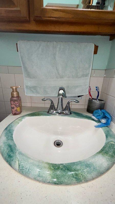 Responded to a clogged bathroom sink drain issue. Upon arrival, inspected the vanity cabinet and sink area to assess the blockage. Accessed the drain assembly beneath the sink by opening the cabinet doors. Identified a loose P-trap connection contributing to drainage problems and potential leak issues. Cleared the clog from the drain line using appropriate plumbing tools and techniques. Tightened and secured all pipe connections under the sink to ensure proper seal and prevent future leaks. Tested the drain flow by running water through the faucet to verify complete clearance and proper drainage. Confirmed all connections were secure and no leaks were present. Left the work area clean with the sink and drain functioning properly.
