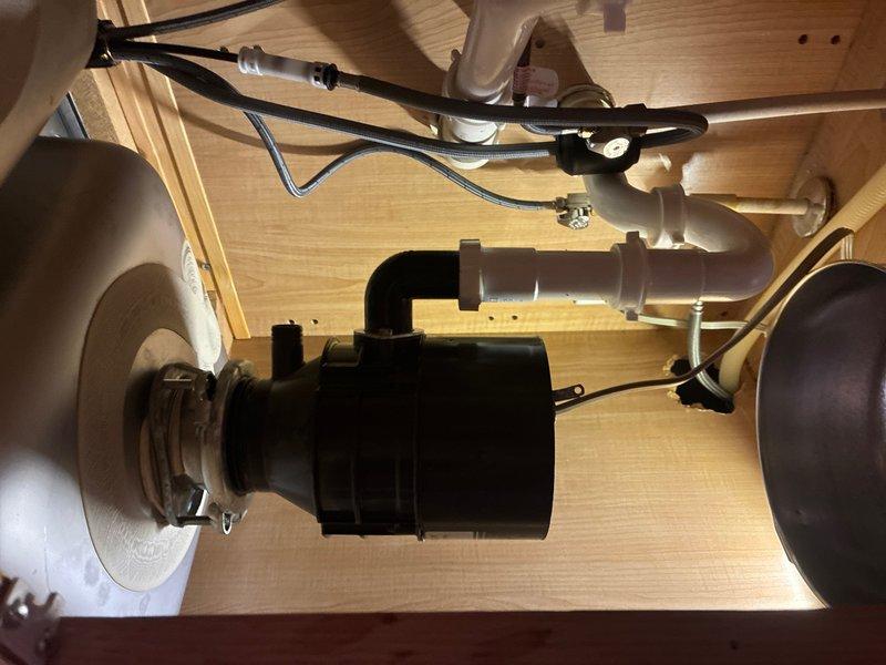 Responded to kitchen sink leak originating from garbage disposal unit on left side of double stainless steel sink. Replaced defective garbage disposal with new unit, ensuring proper mounting and secure connections to drain system. Installed new double-bowl stainless steel kitchen sink and coordinating kitchen faucet with appropriate supply line connections. In both bathrooms, removed existing fixtures and installed matching bathroom sink faucets with updated hardware. Replaced tub and shower faucets in both bathrooms, including new trim kits, valve assemblies, and shower arms. All installations tested for proper operation and inspected for leaks. Verified adequate water pressure and drainage throughout all fixtures. Cleanup completed and all old fixtures removed from premises.