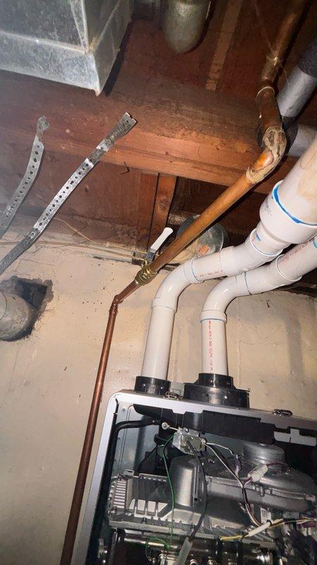 Performed scheduled maintenance flush on tankless water heater system. Descaled unit by circulating cleaning solution through heat exchanger to remove mineral buildup and sediment accumulation. Inspected drain pan for proper condensate drainage, noting mineral deposits and water staining consistent with normal operation. Verified all plumbing connections, inlet/outlet valves, and pressure relief components for proper function. System flushed, tested, and returned to normal operation with improved efficiency.