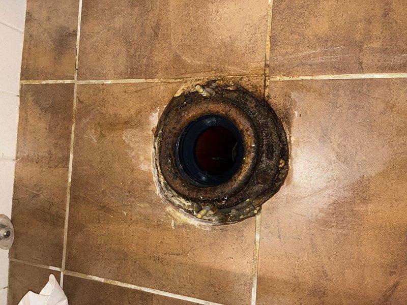Responded to report of toilet leaking at rubber seal in main bathroom. Upon inspection, found severely deteriorated wax ring and flange seal with significant water damage and discoloration around the toilet base and floor flange. Removed and reset toilet, replaced failed wax ring with new seal, and reinstalled unit with proper compression to ensure watertight connection. Verified water supply line connections and tested for leaks upon completion.