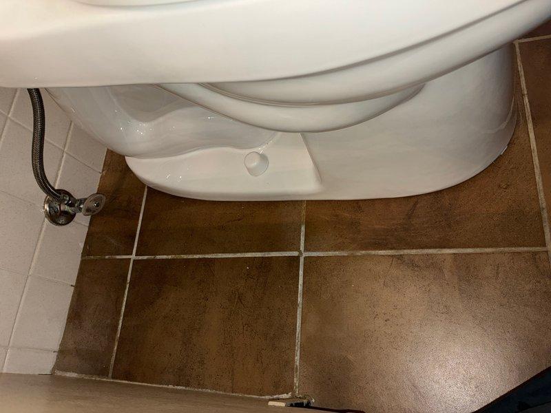 Responded to report of toilet leaking at rubber seal in main bathroom. Upon inspection, found severely deteriorated wax ring and flange seal with significant water damage and discoloration around the toilet base and floor flange. Removed and reset toilet, replaced failed wax ring with new seal, and reinstalled unit with proper compression to ensure watertight connection. Verified water supply line connections and tested for leaks upon completion.