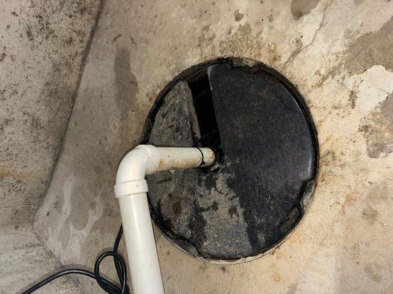 Responded to emergency recall for sump pump failure with water discharge issue. Upon arrival, found disconnected discharge piping at PVC coupling connection, causing water to spray from the apparatus. Customer had unplugged the unit to stop the discharge, resulting in pit refilling. Inspected the 16-year-old system and identified failed connection components. Replaced defective coupling and flexible connectors with new rubber connectors and secured with metal band clamps. Reassembled discharge piping, tested system operation, and verified proper water evacuation with no leaks at connection points.