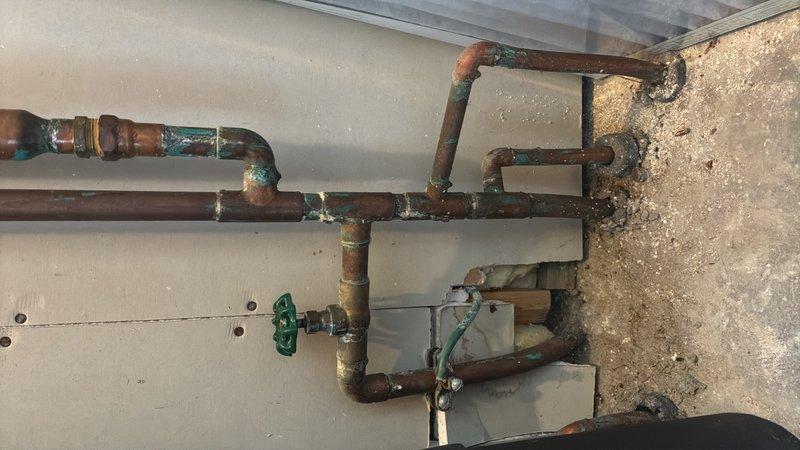 Completed comprehensive plumbing estimate for pressure reducing valve (PRV) installation on existing aged copper piping system. Assessed current pipe configuration, existing corrosion patterns with extensive verdigris formation on joints and fittings, and evaluated optimal placement for PRV integration into the water distribution system to regulate incoming water pressure and protect downstream fixtures and appliances.
