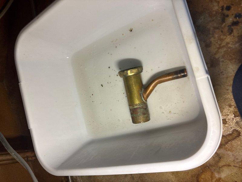 Responded to a water leak issue in a half bath where the P-trap under the sink was actively leaking. Upon inspection, found the existing P-trap assembly had failed connections causing water discharge. Removed and replaced the defective P-trap with new white PVC components, ensuring proper alignment and secure compression fittings. Also inspected the dishwasher discharge line and kitchen sink trap assembly as requested, verifying proper drainage and connection integrity. All plumbing fixtures were tested for leaks and confirmed operational. Removed old corroded brass and copper fittings from the failed assembly. System is now functioning properly with no active leaks detected.