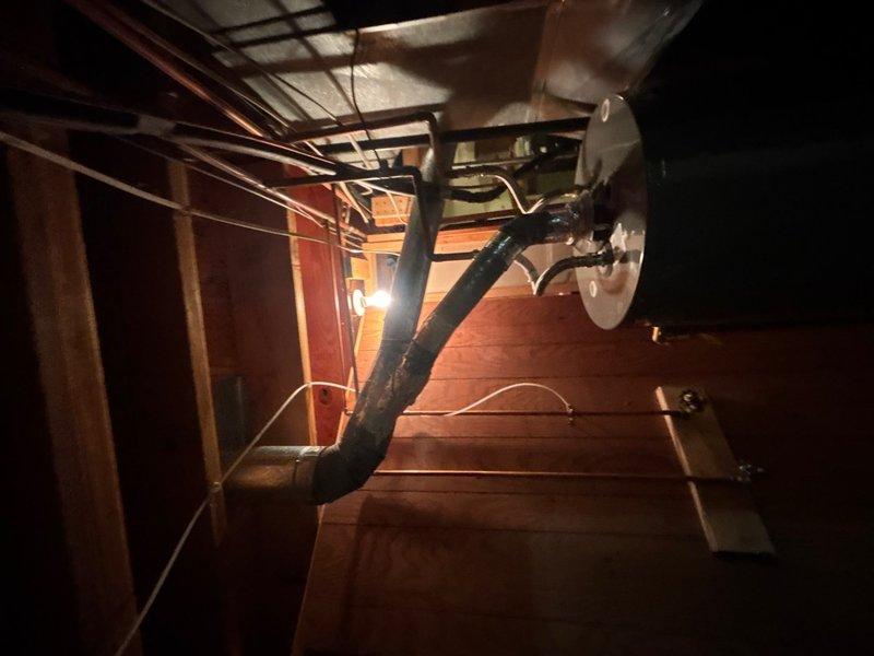 Replaced deteriorated white PVC vent pipe on residential tanked water heater located in basement. Upon inspection, the existing vent showed signs of age-related degradation consistent with the 25-year-old home's mechanical systems. Removed old venting material and installed new properly-sized PVC vent pipe with appropriate fittings to ensure safe exhaust of combustion gases. Verified all connections were secure, properly pitched for condensate drainage, and compliant with current plumbing codes. Tested water heater operation post-installation to confirm proper venting function and customer satisfaction.