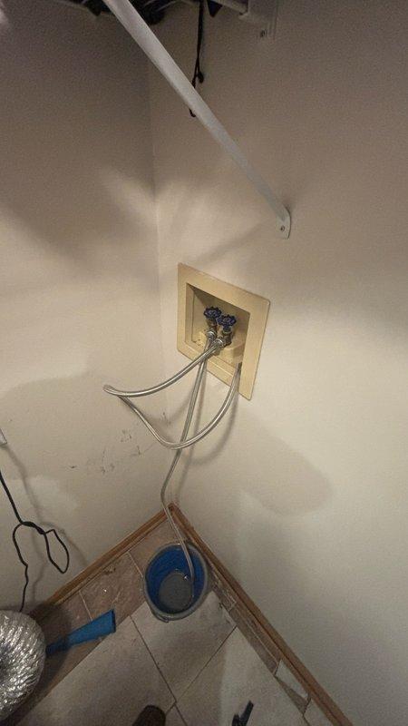 Responded to reported water leak on second level laundry room. Upon inspection, identified leak source at washing machine supply line connection point. Accessed recessed utility box containing dual shutoff valves with flexible stainless steel braided supply hoses. Tightened connection fittings at valve outlets and inspected hoses for wear or damage. Verified proper installation of supply lines and confirmed shutoff valves were functioning correctly. Tested system under pressure to ensure leak was resolved and no additional moisture was present. Area was left clean and operational with all connections secure.