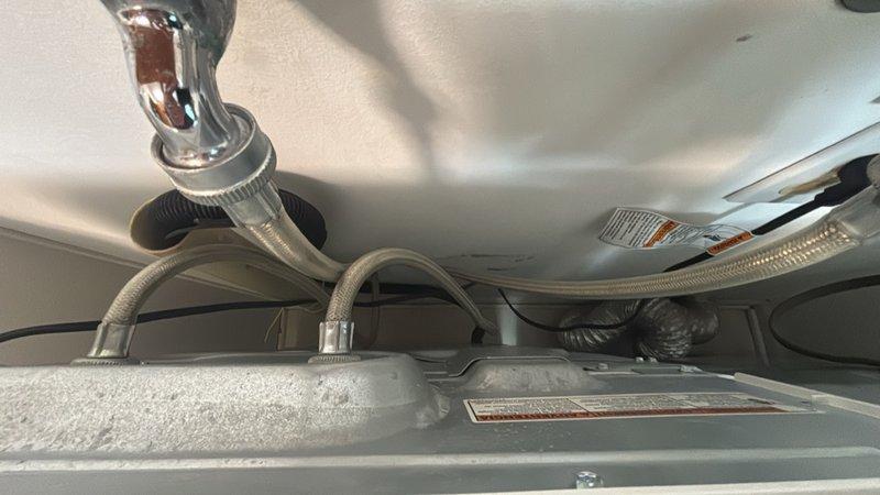 Responded to callback for persistent leak under kitchen sink following previous service visit for clogged drain. Upon inspection, identified leak originating from dishwasher connection points and water supply line fittings beneath the sink cabinet. Tightened braided supply line connections, repositioned drainage components, and verified all plumbing connections were properly sealed and secured to eliminate the ongoing leak issue.
