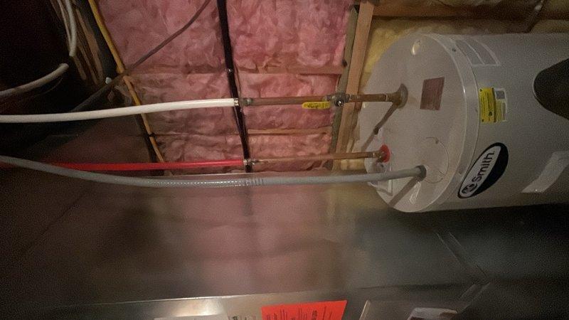 Responded to service call for clogged drain in residential property. Upon inspection, identified drainage issue originating from water heater area in utility space. Cleared blockage from drain line connected to water heater system, removing accumulated debris and sediment causing the obstruction. Verified proper water flow and drainage function through all affected lines. Tested system to ensure complete resolution of clogging issue with no standing water remaining.