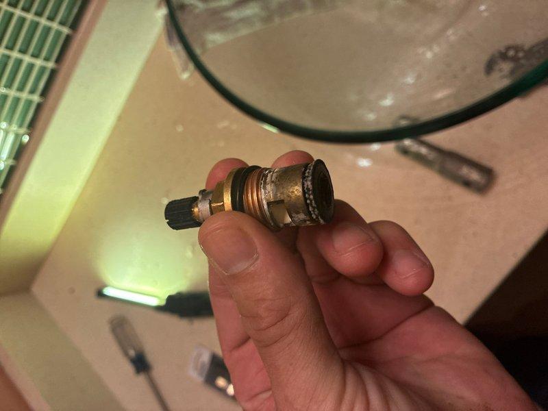Replaced worn cartridges in two wall-mounted, two-handle faucets. Coordinated building water shutoff with 30-minute advance notice as required. Removed old brass valve cartridges showing significant tarnishing and wear, installed new replacement cartridges, and tested both faucet assemblies for proper operation and leak-free performance upon restoration of water service.