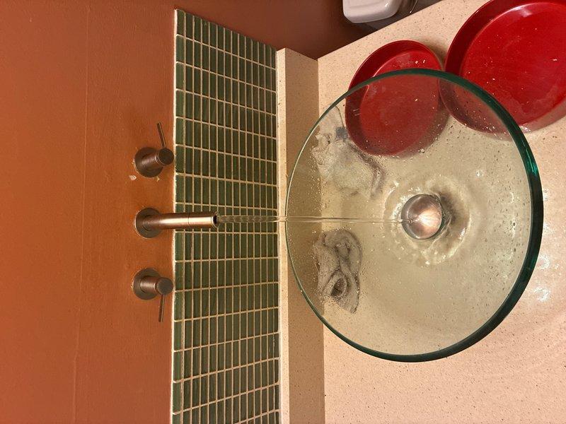 Replaced worn cartridges in two wall-mounted, two-handle faucets. Coordinated building water shutoff with 30-minute advance notice as required. Removed old brass valve cartridges showing significant tarnishing and wear, installed new replacement cartridges, and tested both faucet assemblies for proper operation and leak-free performance upon restoration of water service.