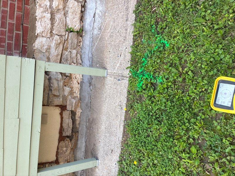 Performed video camera inspection of sewer line and identified a compromised 1-foot section of cast iron pipe at the transition point to PVC. The inspection revealed a hole in the bottom of the cast iron section requiring repair via pipe lining or bursting method. Documented findings with photographic evidence of the interior plumbing system and exterior foundation access point for future repair work.