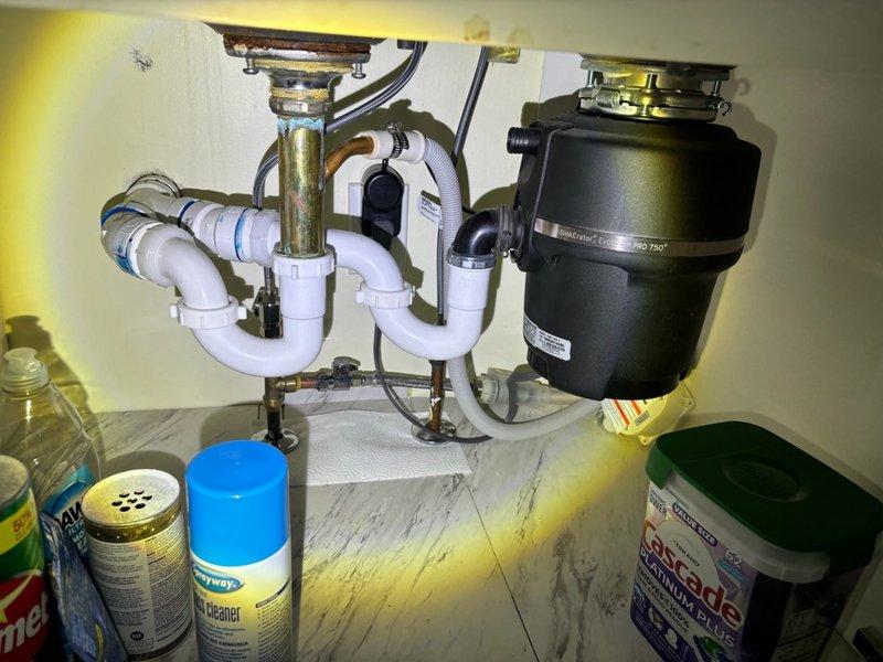 Completed preventative plumbing maintenance inspection on residential property, including thorough examination of kitchen sink plumbing system with PVC drain lines, garbage disposal unit, shutoff valves, and water supply connections. Replaced customer-supplied toilet seat in bathroom and verified proper installation and functionality. All plumbing fixtures inspected and found to be operating within normal parameters with no leaks detected.
