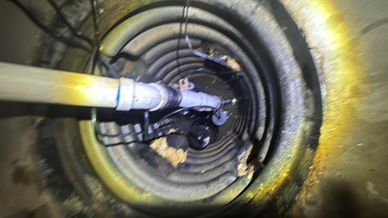 Installed a dual sump pump system featuring a 1/2 HP energy-efficient permanent split capacitor (PSC) primary pump with capacity of 3,540 GPH at 10-foot lift and 4,400 GPH at zero lift, along with a backup pump system rated at 1,850 GPH at 10-foot lift and 2,500 GPH at zero lift. Routed discharge piping through foundation wall using corrugated flexible hose and connected to exterior drainage system with proper insulation at penetration point.