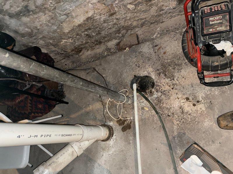 Performed camera inspection of main line and shut off valve in basement using RIDGID SeeSnak inspection equipment. Evaluated plumbing infrastructure including copper piping system with fittings and brackets mounted to structural beams, and assessed 4-inch Schedule 80 PVC pipe condition. Provided quote for shut off valve installation based on inspection findings.