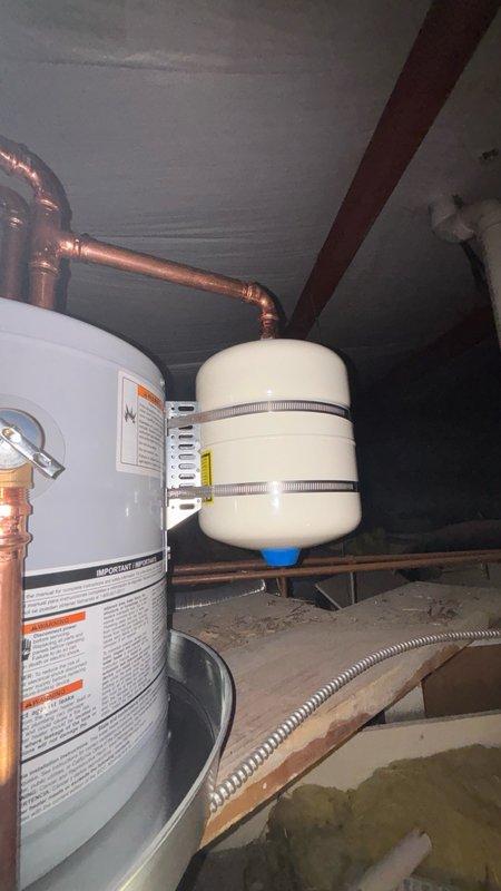 Removed existing commercial tank water heater and installed customer-supplied replacement unit in compliance with current plumbing and electrical codes. Installation included proper electrical disconnect switch with flexible metal conduit for safe service access, new water heater drain pan for leak protection, and thermal expansion tank with copper piping connections. All components were secured according to code requirements, with proper venting and safety labeling verified upon completion.