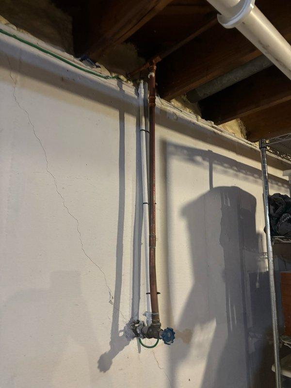 Completed water heater replacement in basement utility area. Removed existing unit and installed new Bradford White BRUTE model water heater with proper venting through existing ductwork system. Connected copper water supply lines, installed blue shutoff valve for system isolation, and verified all plumbing connections for proper operation and code compliance. Unit secured and tested successfully.
