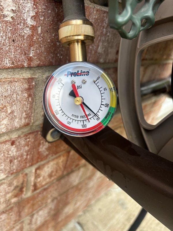 Responded to no hot water complaint for residential water heater over 10 years old located in basement. Upon arrival, inspected Kenmore water heater unit and associated plumbing connections, including pressure gauge and supply lines. Documented existing equipment condition and configuration with photographs showing water heater, furnace, and pressure monitoring equipment. Provided estimate for water heater replacement based on age of unit and lack of hot water production.