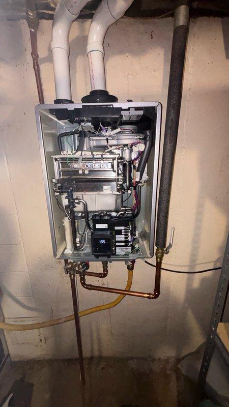 Replaced exhaust gasket on tankless water heater unit. Disassembled internal components to access exhaust tube assembly, removed defective gasket, and installed new warranty replacement gasket. Reassembled unit, restored all connections, and verified proper operation of the system.