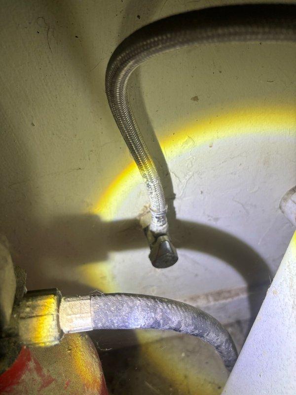 Completed scheduled plumbing maintenance inspection of exterior hose bib and water heater supply connections. Exterior spigot on brick wall showed normal operation with significant efflorescence present on surrounding masonry indicating historical moisture exposure. Inspected water heater flexible supply lines and verified proper installation and connection integrity of braided stainless steel flex lines with no visible leaks or deterioration noted.
