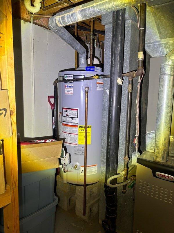 Completed recurring plumbing maintenance inspection at residential property. Evaluated water heater installation, verified proper connections and safety labels, and inspected bathroom sink drain assembly including P-trap and supply lines for leaks or deterioration.